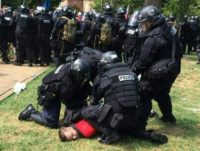 In this twitter hand-out photo courtesy of the Virginia State Police, arrests are being made following the declaration of unlawful assembly at Emancipation Park in Charlottesville, Virginia on August 12, 2017