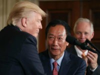 US President Donald Trump shakes hands with Terry Gou (C), Chairman of Foxconn, an electronics supplier, while Sen. Ben Johnson (R-WI) (R) stands nearby during an announcement that the company will open a manufacturing facility in Wisconsin, during an event in the East Room of the White House July 26, 2017 in Washington, DC. The president was touting a decision by Apple supplier Foxconn to invest $10 billion to build a factory in Wisconsin that produces LCD panels. Foxconn said the project would create 3,000 jobs, with the 'potential' to generate 13,000 new jobs, according to published reports. (Photo by Mark Wilson/Getty Images)