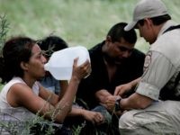 Border Patrol BORSTAR agent administers basic medical attention to illegal immigrants abandoned near Falfurrias, Texas. (AP Photo/Eric Gay)