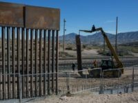 In this March 30, 2017 file photo, Workers use a crane to lift a segment of a new fence into place on the U.S. side of the border with Mexico, where Sunland Park, New Mexico, meets the Anapra neighborhood of Ciudad Juarez, Mexico, As President Donald Trump's administration fights to fund a new, multibillion-dollar border wall, government lawyers are still settling claims with Texas landowners over the fence Congress approved more than a decade ago.