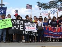 WEST PALM BEACH, FL - MARCH 04: Supporters of President Donald Trump and people against his presidency stand near each other down the road from the Mar-a-Lago resort home of President Trump on March 4, 2017 in West Palm Beach, Florida. President Trump spent part of the weekend at the house. (Photo by Joe Raedle/Getty Images)