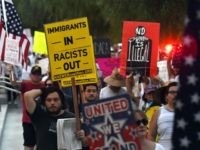 Immigrants and supporters chant during a 