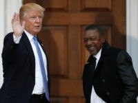 FILE - In this Nov. 20, 2016 file photo, President-elect Donald Trump stands with BET founder Robert Johnson at the Trump National Golf Club Bedminster clubhouse in Bedminster, N.J.. Johnson is one of dozens of people who have paraded into Trump’s properties in New York and New Jersey in recent weeks for job interviews and other consultations with the Republican. Several described the meetings as serious, yet conversational, with the president-elect leading the discussion and asking questions extemporaneously, without consulting notes. (AP Photo/Carolyn Kaster, File)