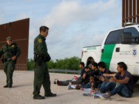 Border Patrol agents apprehend illegal immigrants shortly after they crossed the border from Mexico into the United States on Monday, March 26, 2018 in the Rio Grande Valley Sector near McAllen, Texas. An estimated 11 million undocumented immigrants live in the United States, many of them Mexicans or from other Latin American countries. / AFP PHOTO / Loren ELLIOTT (Photo credit should read LOREN ELLIOTT/AFP/Getty Images)