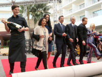 Meher Tatna, from left, Simone Garcia Johnson, Seth Meyers, Allen Shapiro, Barry Adelman and Lili Bosse roll-up the red carpet at the 75th Annual Golden Globe Awards Preview Day at The Beverly Hilton on Thursday, Jan. 4, 2018, in Beverly Hills, Calif. (Photo by Willy Sanjuan/Invision/AP)